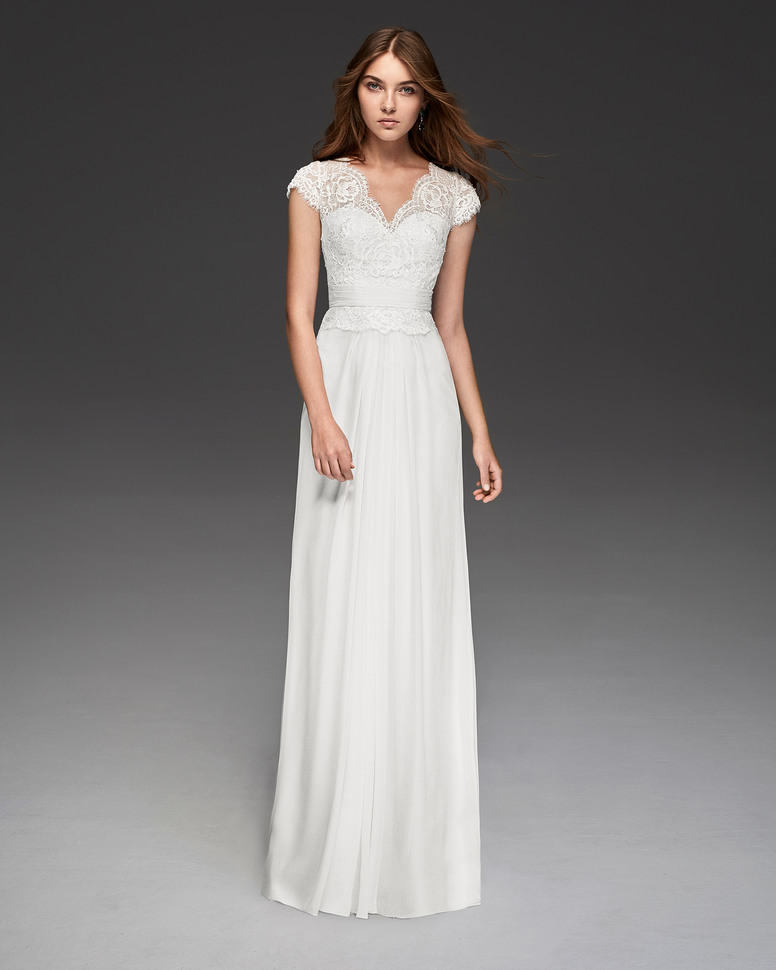 Boho-style beaded crepe Georgette wedding dress with short sleeves and V-neckline.