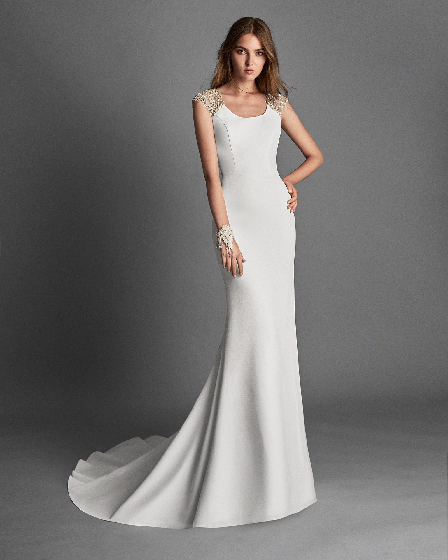Mermaid-style crepe wedding dress with short sleeves and beaded lace back.