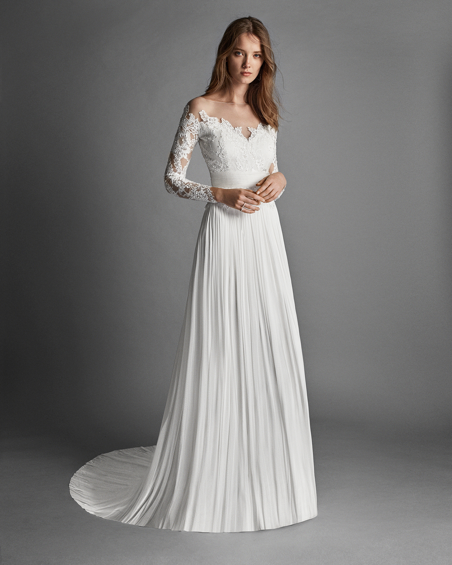 Classic-style muslin and lace wedding dress with long sleeves, low back and beadwork detail.