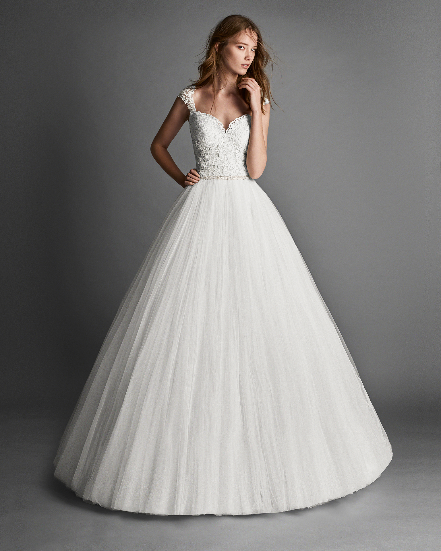 Princess-style beaded lace and tulle wedding dress with lace back.