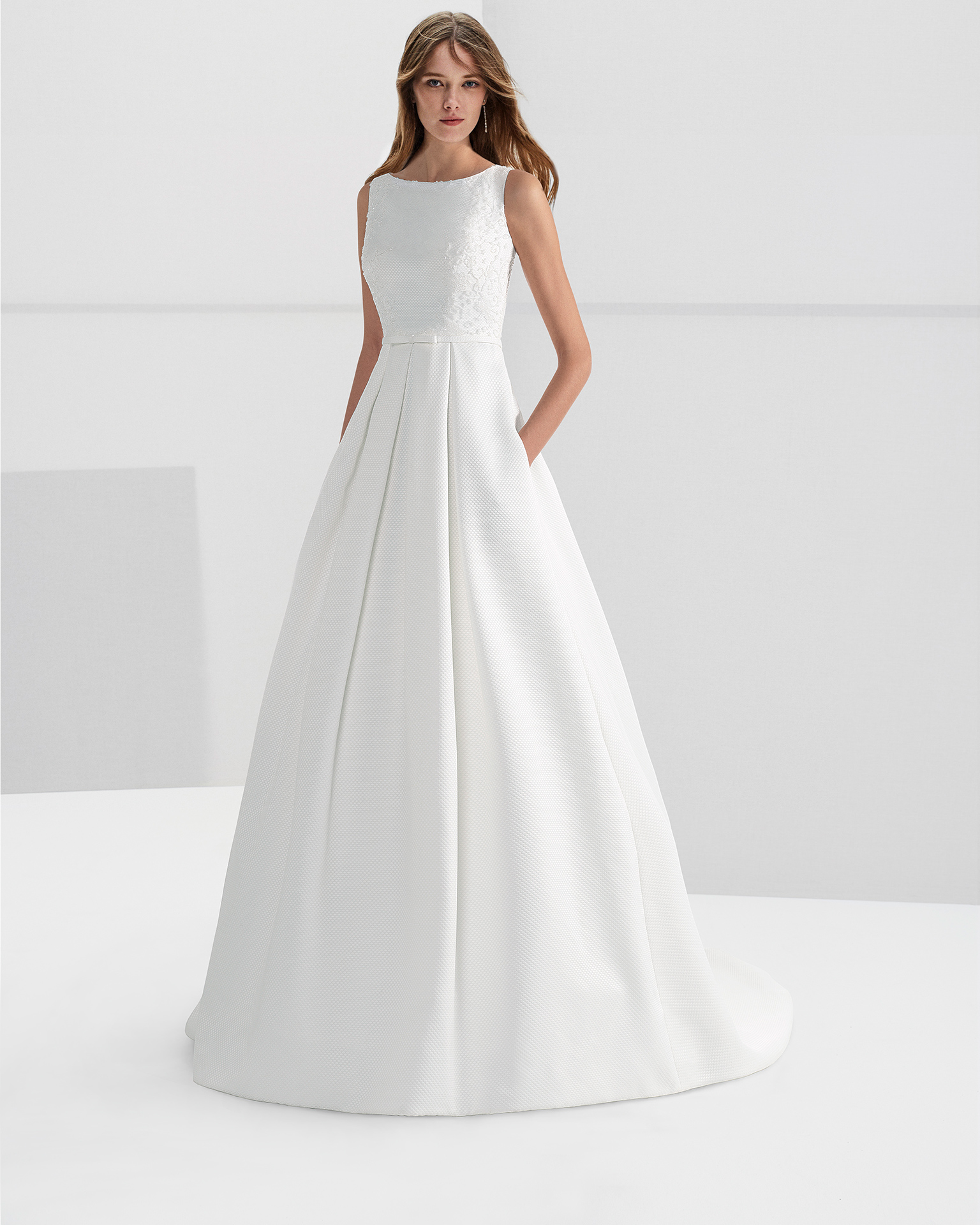 Classic-style beaded piqué wedding dress with bateau neckline and pockets.