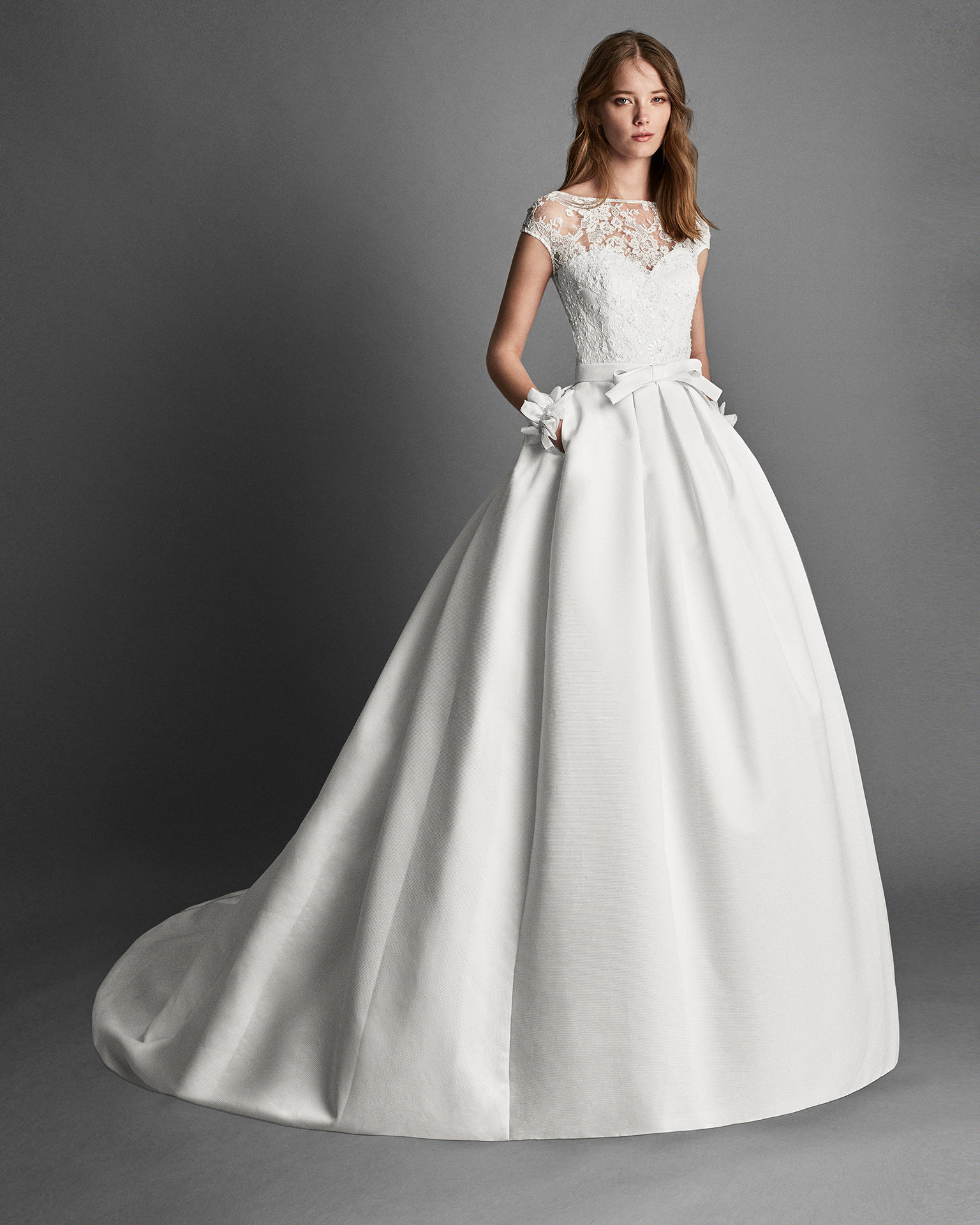 Classic-style beaded lace and Ottoman wedding dress with short sleeves, bateau neckline and pockets, in ivory.