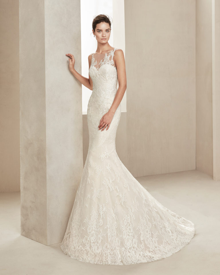 Mermaid-style wedding dress in beaded lace. With illusion neckline. Available in natural. 2019 ALMANOVIA Collection.