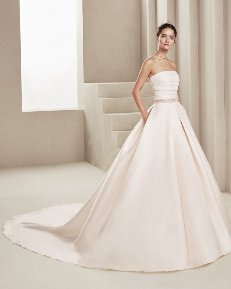 Classic gazar wedding dress. With strapless neckline and beading at the waist. Available in rose and natural. 2019 ALMANOVIA Collection.
