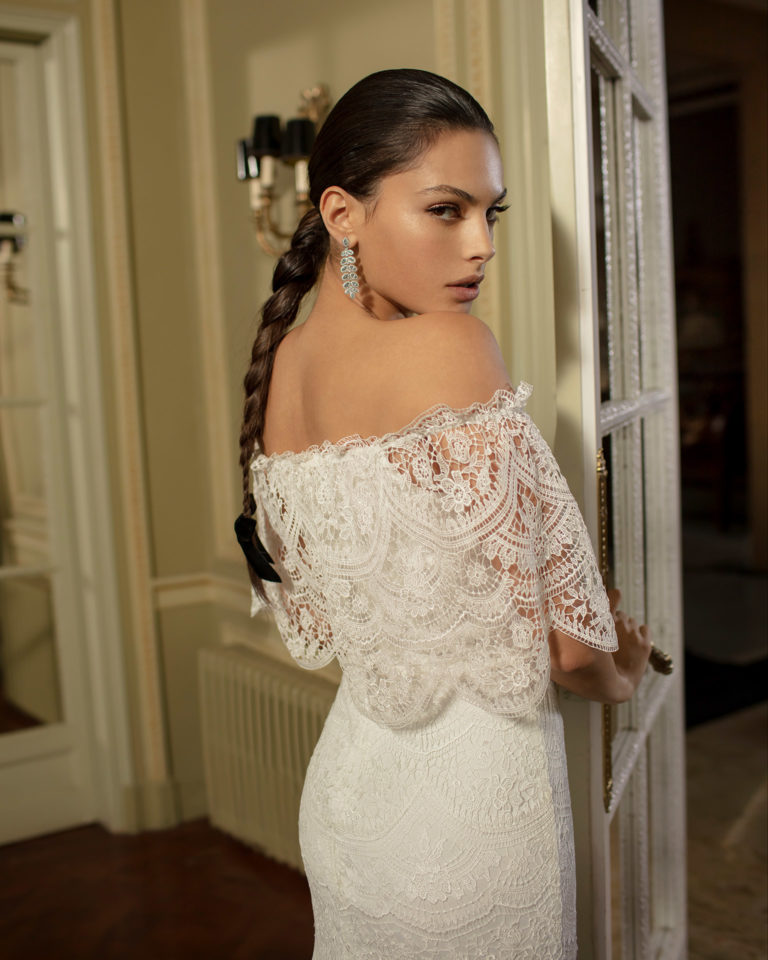 Vestido de novia estilo boho de encaje con escote bajo hombro y volantes. Colección ALMANOVIA 2020.